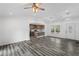 Sun-lit living room features an open concept to the kitchen, recessed lighting, and modern flooring at 1752 Atherton Dr, Decatur, GA 30035