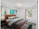 Stylishly decorated main bedroom with hardwood floors, large windows, and neutral tones at 1752 Atherton Dr, Decatur, GA 30035