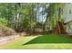 Large, well-maintained backyard with a wooden fence and mature trees providing privacy at 2731 Old Coach Rd, Duluth, GA 30096