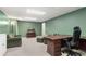Finished basement features an office space with desk, couch, and shelving with ample lighting at 2731 Old Coach Rd, Duluth, GA 30096