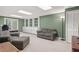 Finished basement features an entertainment area with a couch, chairs, and built in shelving at 2731 Old Coach Rd, Duluth, GA 30096