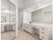 Bright bathroom with double vanity, makeup counter, and full length mirrors at 2731 Old Coach Rd, Duluth, GA 30096