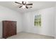 A bright bedroom is shown with a wooden dresser and large window providing natural light at 2731 Old Coach Rd, Duluth, GA 30096