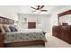 Bright primary bedroom with modern furniture, neutral walls and ceiling fan at 2731 Old Coach Rd, Duluth, GA 30096
