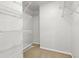 Walk-in closet with wire shelving and neutral carpeting at 2731 Old Coach Rd, Duluth, GA 30096