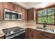 Kitchen featuring stainless steel appliances, wood cabinets and backsplash at 2731 Old Coach Rd, Duluth, GA 30096