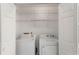 Clean laundry room features a washer, dryer, and wire shelving for maximum organization at 2731 Old Coach Rd, Duluth, GA 30096