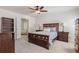 Well-lit main bedroom boasts modern furniture, ceiling fan, and access to ensuite at 2731 Old Coach Rd, Duluth, GA 30096