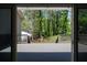 Back Deck view of trees and backyard through sliding glass doors at 8876 Ashwood Dr, Riverdale, GA 30274