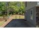 Backyard view of home and yard with a fenced gate at 8876 Ashwood Dr, Riverdale, GA 30274