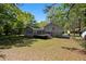 Backyard with deck and stairs leading down to the lawn at 8876 Ashwood Dr, Riverdale, GA 30274