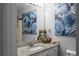 Bathroom vanity featuring granite countertops, framed mirror and sconce lighting at 8876 Ashwood Dr, Riverdale, GA 30274