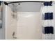 Bright bathroom with shower/tub combo featuring white tile and accents at 8876 Ashwood Dr, Riverdale, GA 30274