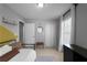 Bright bedroom features neutral walls, a window with white drapes, and minimal decor at 8876 Ashwood Dr, Riverdale, GA 30274
