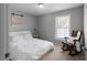 Bedroom with natural light, rocking chair, and bright white accents at 8876 Ashwood Dr, Riverdale, GA 30274