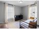 Cozy bedroom with ample natural light from two windows and neutral decor at 8876 Ashwood Dr, Riverdale, GA 30274