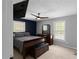 Bedroom featuring dark wood furniture, neutral paint and contemporary ceiling fan at 8876 Ashwood Dr, Riverdale, GA 30274