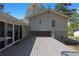 View of gray wooden deck attached to home with gray siding and glass doors, perfect for outdoor living at 8876 Ashwood Dr, Riverdale, GA 30274