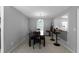 Bright dining room featuring a chandelier, table with seating, and a pass-through to the kitchen at 8876 Ashwood Dr, Riverdale, GA 30274