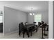 The dining area with a chandelier, complemented by a dark wood table and seating at 8876 Ashwood Dr, Riverdale, GA 30274