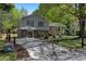Split-level home with stone accents, a well-maintained lawn, and a long driveway at 8876 Ashwood Dr, Riverdale, GA 30274