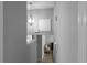 Bright hallway featuring a modern chandelier and neutral color palette at 8876 Ashwood Dr, Riverdale, GA 30274