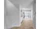 Hallway with neutral walls, tile flooring, and open views to other rooms, creating a seamless flow at 8876 Ashwood Dr, Riverdale, GA 30274