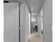 Hallway with white trim and neutral paint, leading to bedrooms at 8876 Ashwood Dr, Riverdale, GA 30274