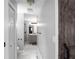 Hallway leading to bathroom with tile flooring, shower and vanity at 8876 Ashwood Dr, Riverdale, GA 30274