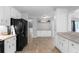 Spacious kitchen showcasing white cabinets, granite countertops, and tile flooring at 8876 Ashwood Dr, Riverdale, GA 30274