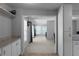 Bright kitchen area with white cabinets, granite countertops, and open view to living area at 8876 Ashwood Dr, Riverdale, GA 30274