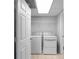 Laundry room featuring a washer, dryer, tiled flooring, and a wire shelf for storage at 8876 Ashwood Dr, Riverdale, GA 30274