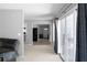 Bright living room featuring neutral walls, sliding glass doors, and seamless transition to the kitchen area at 8876 Ashwood Dr, Riverdale, GA 30274