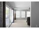 Living room with sliding glass doors, natural light, and neutral carpeting at 8876 Ashwood Dr, Riverdale, GA 30274