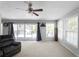 Cozy living room with a sliding glass door leading to a deck and neutral carpeting at 8876 Ashwood Dr, Riverdale, GA 30274