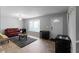 View of an open-concept living room showcases the room with bay window and light walls at 8876 Ashwood Dr, Riverdale, GA 30274