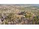 Aerial view of a home surrounded by a dense forest at 998 Sisley Trl, White, GA 30184