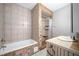 Well-lit bathroom featuring tiled walls, a shower stall, and a bathtub for relaxation at 998 Sisley Trl, White, GA 30184