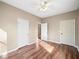 Spacious bedroom with wood floors and three doors, creating a versatile living space at 998 Sisley Trl, White, GA 30184