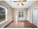 Bright bedroom with wood flooring, large windows, and white curtains for a welcoming atmosphere at 998 Sisley Trl, White, GA 30184