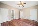 Spacious bedroom with wood floors and ceiling fan, showcasing three entry doors at 998 Sisley Trl, White, GA 30184