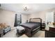 Primary bedroom with a full-size bed, and a window view to the landscape at 998 Sisley Trl, White, GA 30184