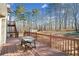 Wooden deck with a picnic table, offering space for outdoor dining and relaxation at 998 Sisley Trl, White, GA 30184