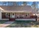 Close up of charming front porch with cozy seating and a welcoming entrance at 998 Sisley Trl, White, GA 30184
