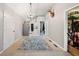 Hallway with a carpet floor, chandelier, and wall decor at 998 Sisley Trl, White, GA 30184