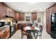 Updated kitchen with dark wood cabinetry, stainless steel appliances, and a charming breakfast nook at 998 Sisley Trl, White, GA 30184