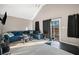 Bright living room with a large sofa and sliding glass doors to the deck at 998 Sisley Trl, White, GA 30184