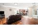 Open-concept living room with hardwood floors, a comfy sofa, and a view into the kitchen and bathroom at 998 Sisley Trl, White, GA 30184