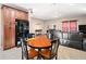 Open-concept living room featuring a black refrigerator, dining table, and leather sofa at 998 Sisley Trl, White, GA 30184