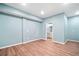 Finished basement living area with wood-look floors, and doorway to bathroom at 998 Sisley Trl, White, GA 30184